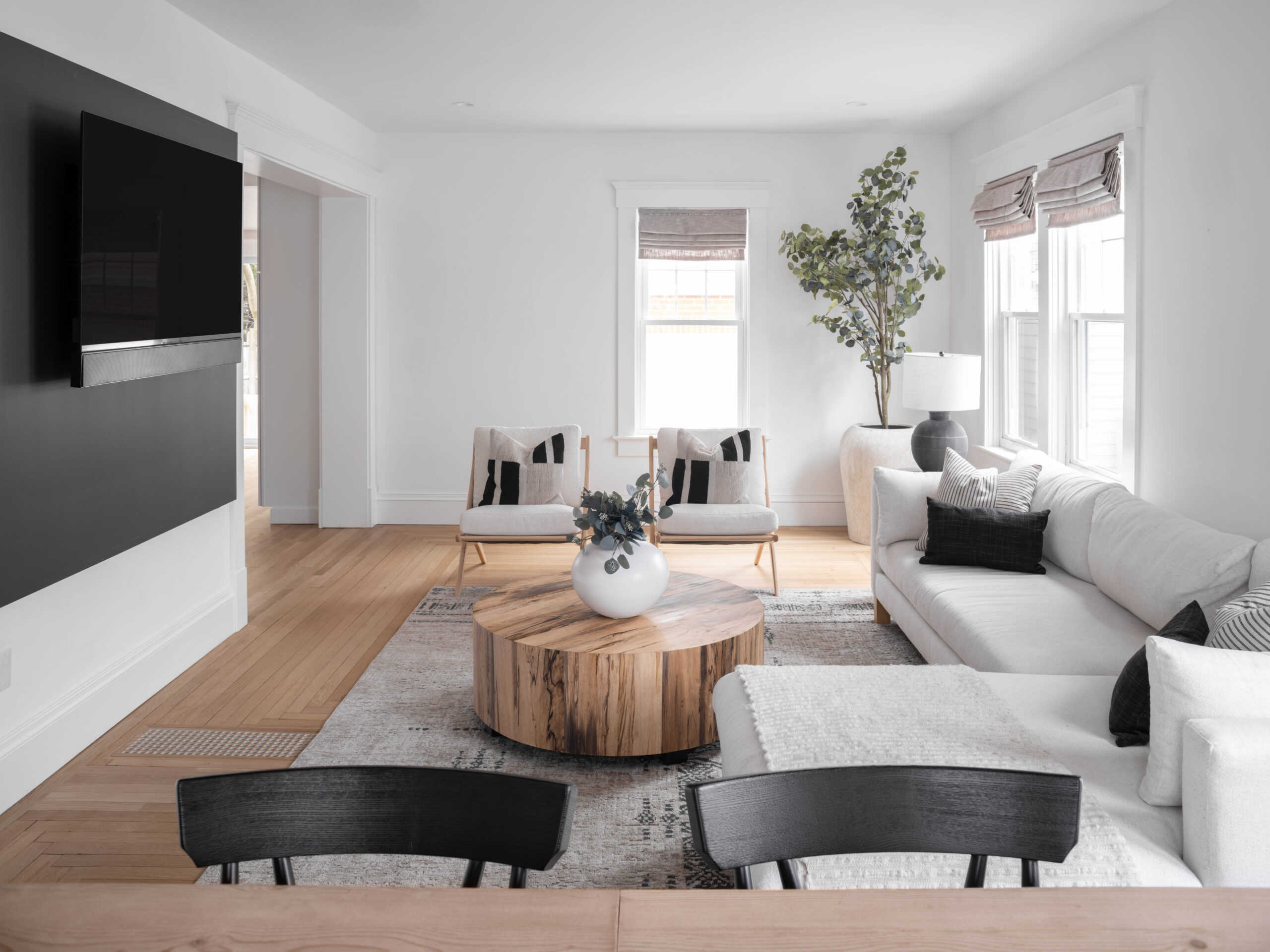Wide view of the transformed living space, showing the improved flow and natural light achieved through the renovation.