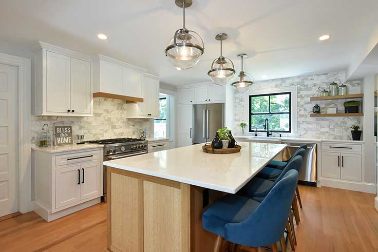 Gourmet kitchen renovation featuring a large island with quartz countertops and custom cabinetry.