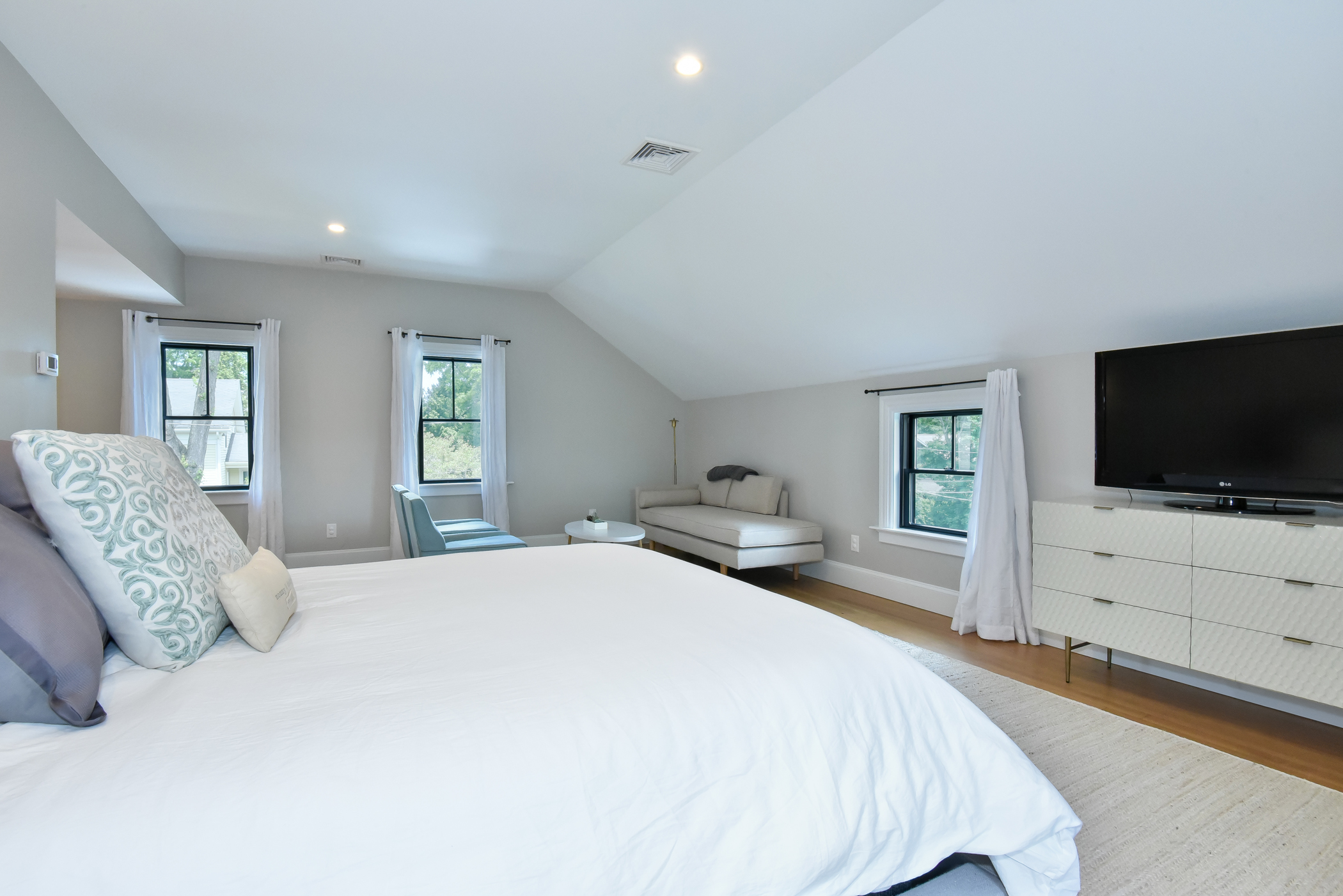 Relaxing bedroom retreat with ample natural light, showcasing the quality of the interior renovation.