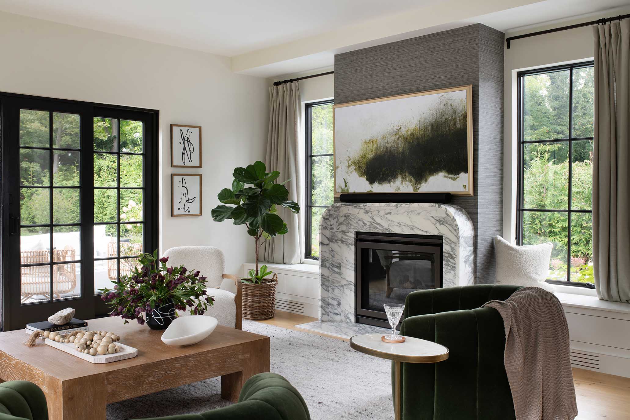 Open-concept living room with a fireplace, designed to offer the "weather-worn elegance" and comfort required for Rhode Island seasons.