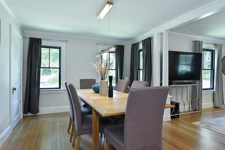 Light-filled dining area adjacent to the kitchen, perfect for casual family meals or formal gathering.